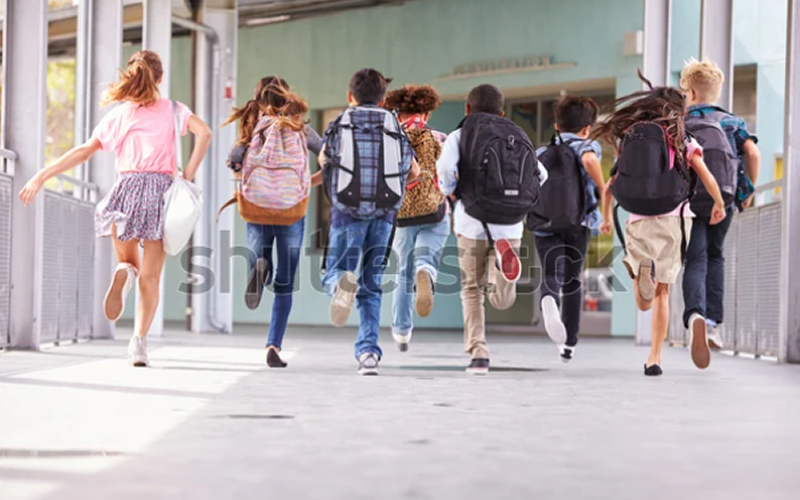 Children with Backpacks in School Yard: TRU47 Back to School Essentials