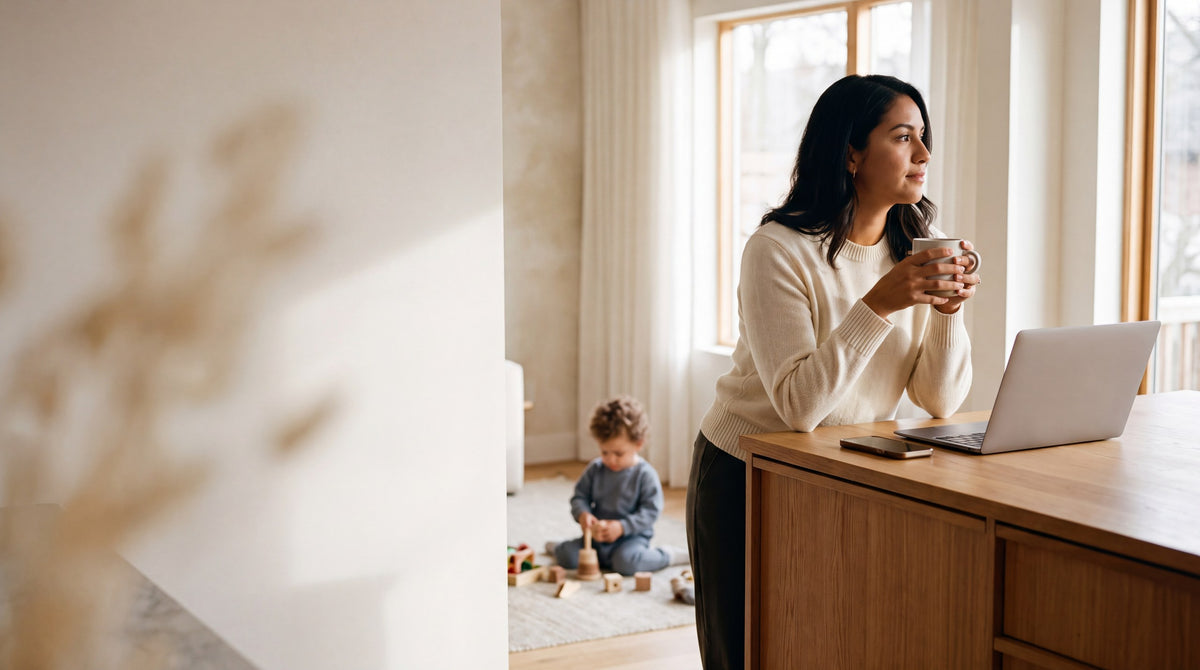 A woman at a kitchen counter in morning light